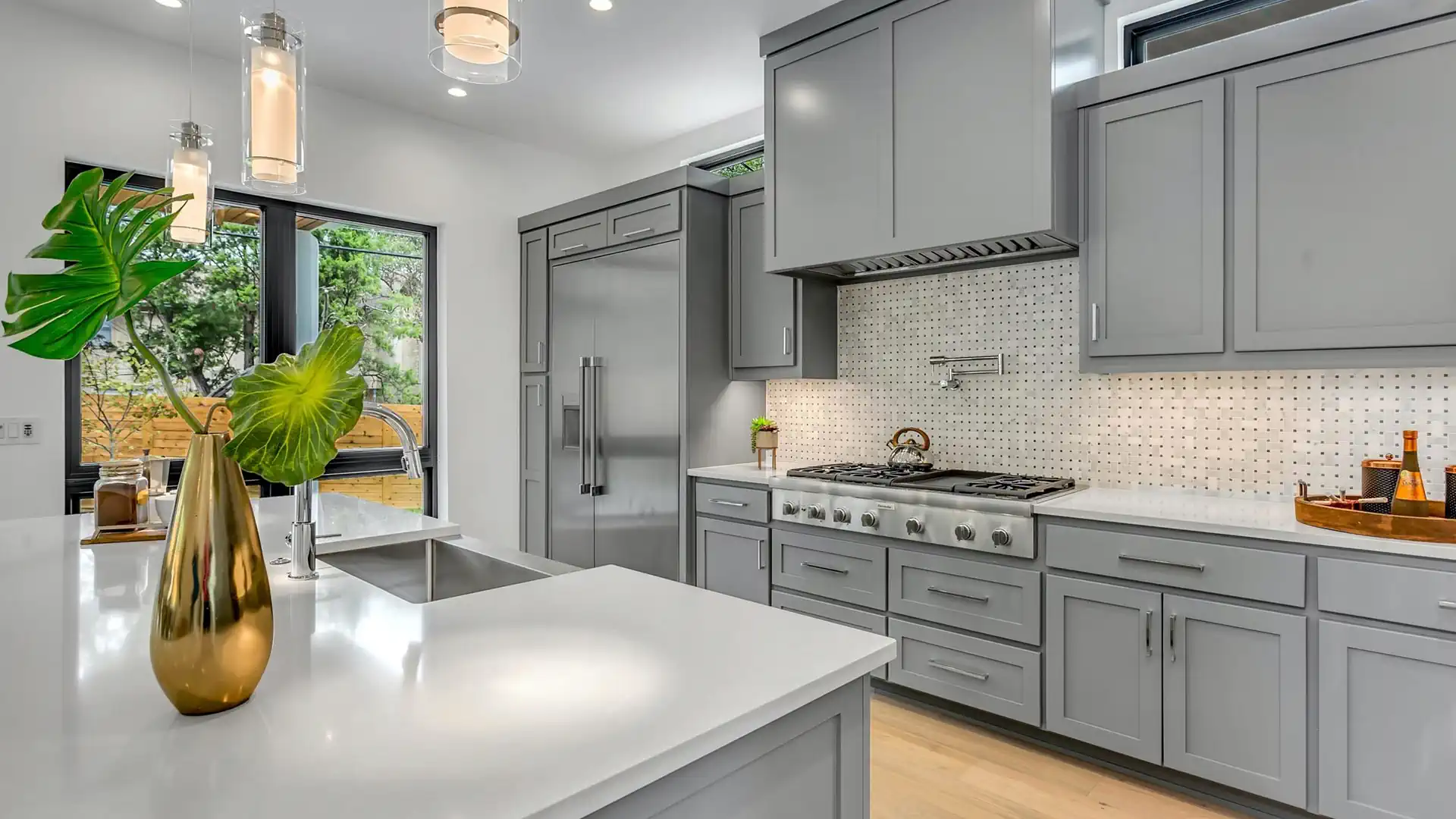 Gray cabinets, white countertops, and a bright kitchen from Wences Pro Painting’s website